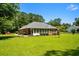 Beautiful home exterior with a well-manicured lawn and mature trees at 1478 Bluegil Dr., Longs, SC 29568