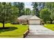 Brick home with a green lawn, brick entryway, and large trees at 1478 Bluegil Dr., Longs, SC 29568