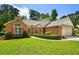 Beautiful brick home with a manicured lawn and attached two-car garage at 1478 Bluegil Dr., Longs, SC 29568