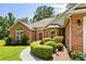 Attractive brick home with manicured landscaping and a curved walkway at 1478 Bluegil Dr., Longs, SC 29568