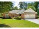 Charming brick home with a well-manicured lawn and a two-car garage at 1478 Bluegil Dr., Longs, SC 29568