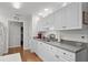 Traditional kitchen features white cabinetry, hardwood floors and stainless steel double sink at 1478 Bluegil Dr., Longs, SC 29568