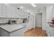Well-maintained kitchen with white cabinets, modern appliances, hardwood floors, and plenty of counter space at 1478 Bluegil Dr., Longs, SC 29568