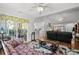 Open-concept living room boasts hardwood floors, a view of the kitchen, and glass doors to the patio at 1478 Bluegil Dr., Longs, SC 29568