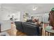 Relaxing living room with hardwood floors and leather sofas that lead to the kitchen and dining area at 1478 Bluegil Dr., Longs, SC 29568