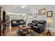 Comfortable living room with hardwood floors, ceiling fan and leather sofas, great for relaxing or entertaining guests at 1478 Bluegil Dr., Longs, SC 29568