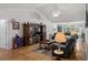Spacious living room featuring vaulted ceilings, hardwood floors, and a large entertainment center at 1478 Bluegil Dr., Longs, SC 29568