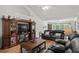 Bright living area with hardwood floors, ceiling fan and a charming entertainment center with a vintage sewing machine at 1478 Bluegil Dr., Longs, SC 29568