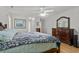 Main bedroom with hardwood floors, neutral paint, ceiling fan, and traditional furnishings at 1478 Bluegil Dr., Longs, SC 29568