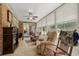 Comfortable sunroom with multiple seating areas, tiled floor, and natural light at 1478 Bluegil Dr., Longs, SC 29568