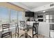 Open dining space with bar seating, a flat screen TV, and view of the city at 1605 S Ocean Blvd. # 1403, Myrtle Beach, SC 29577