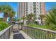 Beautiful building exterior with lush landscaping and palm trees at 1605 S Ocean Blvd. # 1403, Myrtle Beach, SC 29577