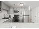 Modern kitchen with stainless steel appliances, gray cabinets, and marble countertops at 1605 S Ocean Blvd. # 1403, Myrtle Beach, SC 29577