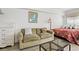 Inviting living area with a sofa, dresser, and view of a comfortable queen sized bed at 1605 S Ocean Blvd. # 1403, Myrtle Beach, SC 29577