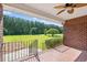 Brick back porch with a railing overlooking a large lawn and green trees at 1752 Patriot Ct., Mullins, SC 29574