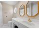 Bathroom featuring double vanity, mirrors with gold frames, and a window at 1752 Patriot Ct., Mullins, SC 29574
