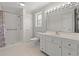 Bright bathroom with a shower, white vanity, and ample lighting at 1752 Patriot Ct., Mullins, SC 29574