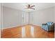 Bedroom with hardwood floors, mirrored closet doors, ceiling fan, and plantation shutters at 1752 Patriot Ct., Mullins, SC 29574