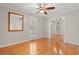 Bedroom featuring hardwood floors, closet with mirrored doors and a ceiling fan at 1752 Patriot Ct., Mullins, SC 29574