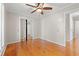 Bedroom featuring hardwood floors, closet with mirrored doors and a ceiling fan at 1752 Patriot Ct., Mullins, SC 29574