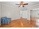 Bedroom with hardwood floors, mirrored closet doors and a blue patterned chair at 1752 Patriot Ct., Mullins, SC 29574