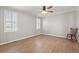 Bright bedroom featuring wood-look flooring, neutral walls, and shuttered windows at 1752 Patriot Ct., Mullins, SC 29574