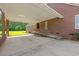 View of the home's attached brick carport with a ramp and ample space for parking at 1752 Patriot Ct., Mullins, SC 29574