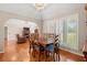 Open dining area flows into a living room with a fireplace and large windows at 1752 Patriot Ct., Mullins, SC 29574