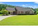 Charming brick home with manicured lawn, attached carport, and mature tree in a desirable neighborhood at 1752 Patriot Ct., Mullins, SC 29574