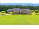 View of the brick home with well-manicured lawn, long driveway, carport, and mature trees at 1752 Patriot Ct., Mullins, SC 29574
