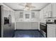 Bright kitchen featuring white cabinetry, stainless steel appliances, and unique blue tile flooring at 1752 Patriot Ct., Mullins, SC 29574