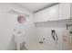 Clean laundry room with utility sink, storage cabinets, and water heater at 1752 Patriot Ct., Mullins, SC 29574