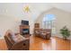 Comfortable living room with vaulted ceiling, fireplace, and large arched windows at 1752 Patriot Ct., Mullins, SC 29574