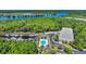 Expansive aerial view showcasing a river, lush greenery, a marina, and community pool with surrounding buildings at 179 Cottage Ct., Pawleys Island, SC 29585
