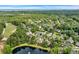 Aerial view of a lush community with tree-lined streets, waterfront properties, golf course, and ocean views in the distance at 179 Cottage Ct., Pawleys Island, SC 29585