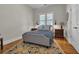 Cozy bedroom with a blue patterned bed, bedside tables with lamps, hardwood floors and a decorative area rug at 179 Cottage Ct., Pawleys Island, SC 29585