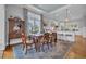 Charming dining room that flows into the adjacent kitchen featuring a stylish light fixture and large windows at 179 Cottage Ct., Pawleys Island, SC 29585