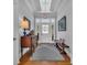 Elegant foyer featuring hardwood floors, a charming wooden bench, and stylish furniture complemented by an ornate light fixture at 179 Cottage Ct., Pawleys Island, SC 29585