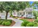 Charming single-Gathering home featuring a lush front yard and a welcoming front porch area with a detached garage at 179 Cottage Ct., Pawleys Island, SC 29585