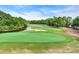 Scenic view of a lush green golf course with trees, water features and sand traps, promoting outdoor recreation at 179 Cottage Ct., Pawleys Island, SC 29585