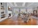 Spacious living room with built-in bookshelves, a cozy fireplace, and multiple French doors that open to the backyard at 179 Cottage Ct., Pawleys Island, SC 29585