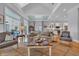 Comfortable living room featuring stylish seating, hardwood floors, and an open view to the adjacent kitchen and dining area at 179 Cottage Ct., Pawleys Island, SC 29585