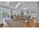 Bright and airy living room with skylights, large windows, and comfortable seating arrangement at 179 Cottage Ct., Pawleys Island, SC 29585