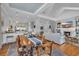 Open-concept living space with a kitchen island, wooden dining table, and a comfortable seating area with a fireplace at 179 Cottage Ct., Pawleys Island, SC 29585