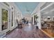 Light-filled sun room with brick floors, a blue ceiling, and lots of natural light at 179 Cottage Ct., Pawleys Island, SC 29585