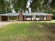 Charming brick home with a well-manicured lawn and attached carport at 189 Lewis Rd., Hemingway, SC 29554