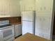 Kitchen with white cabinets, wood countertops, and appliances, offering a classic design at 189 Lewis Rd., Hemingway, SC 29554
