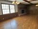 Bright living room featuring hardwood floors and a brick fireplace at 189 Lewis Rd., Hemingway, SC 29554