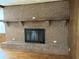 Brick fireplace with a wooden mantel, complemented by hardwood floors at 189 Lewis Rd., Hemingway, SC 29554