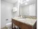 Bathroom featuring vanity with granite counters, a sink, a toilet and a mirror at 2000 N Ocean Blvd. # 1810, Myrtle Beach, SC 29577